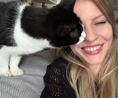 Cat sitting by Angelina in Camden